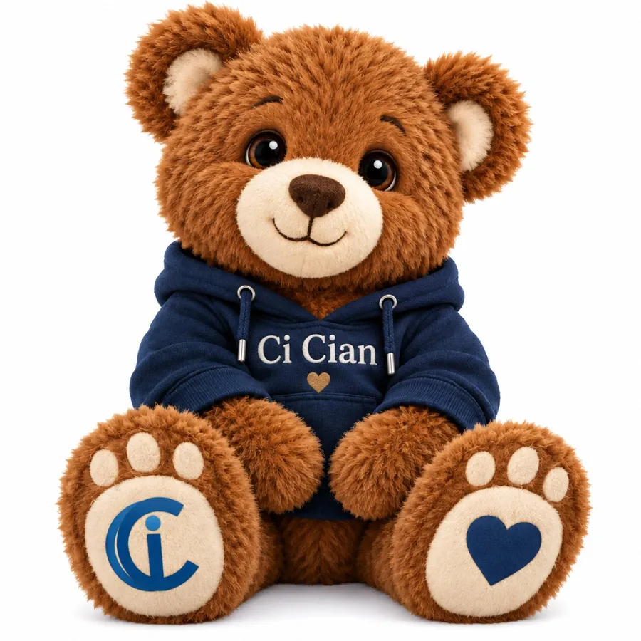 Ci Cian, a brown teddy bear in a navy hoodie with a gold heart, sitting and smiling at the camera.